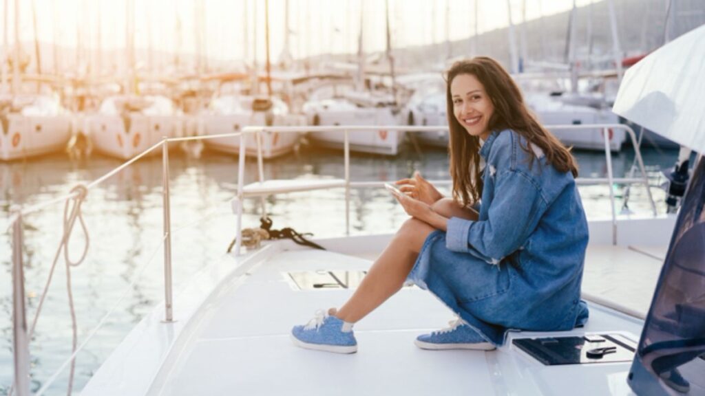 Woman Enjoying A Boat Ride While On Her Phone