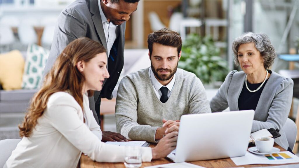 Group Of Professionals Working On Laptop