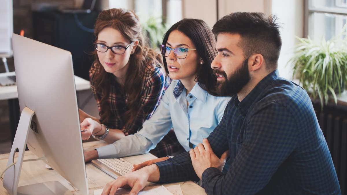 Group Of People Looking At A Computer